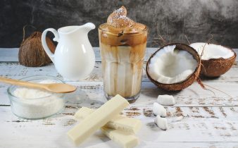 white ceramic pitcher beside clear glass pitcher on brown wooden table